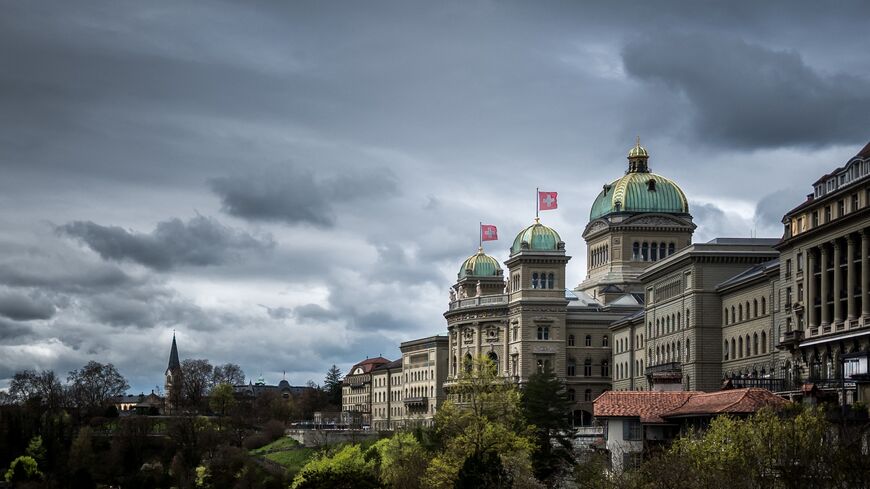 This photograph taken on April 3, 2024, shows the House of Swiss Parliament under heavy clouds in Swiss capital Bern.