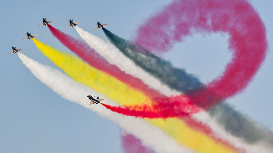TOPSHOT - Chengdu J-10 Vigorous Dragon fighter aircraft of China's Ba Yi (August 1st) Aerobatics Team release smoke while performing manoeuvres during the first Egypt International Airshow at Alamein International Airport in Alamein in northern Egypt on September 4, 2024. (Photo by Khaled DESOUKI / AFP) (Photo by KHALED DESOUKI/AFP via Getty Images)