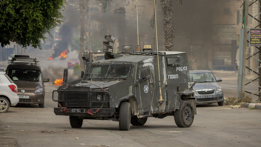An Israeli military vehicle moves through a street in Balata refugee camp, east of Nablus, West Bank, Oct. 1, 2024.