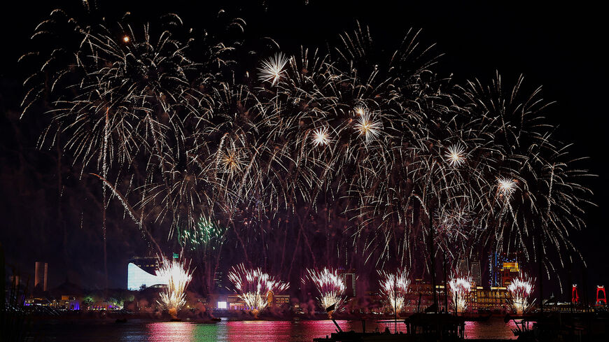 Fireworks light up the sky over the Katara Cultural Village in Doha during celebrations for the first day of the Muslim holiday of Eid al-Fitr, a holiday marking the end of the holy month of Ramadan on March 30, 2025. (Photo by KARIM JAAFAR / AFP) (Photo by KARIM JAAFAR/AFP via Getty Images)