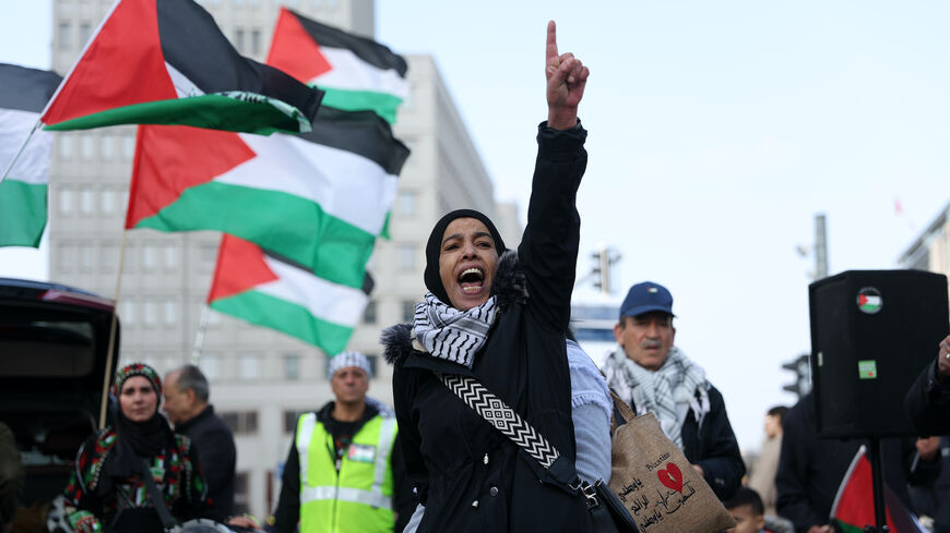 A protestor shouts during a gathering to commemorate Land Day on March 29, 2025 in Berlin, Germany.