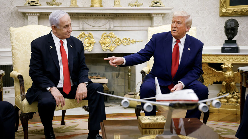 US President Donald Trump (R), accompanied by Israeli Prime Minister Benjamin Netanyahu, speaks during a meeting in the Oval Office of the White House, Washington, April 7, 2025.