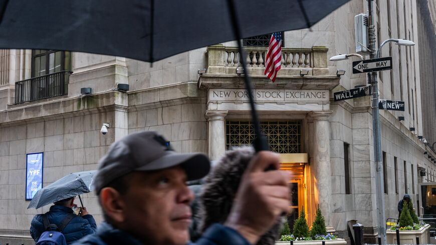 People walk past the New York Stock Exchange on Wall Street on April 11, 2025, in New York City.