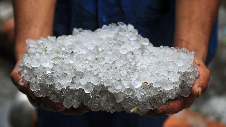 Hailstones covered the ground and battered seafront businesses during the storm in Egypt's Alexandria