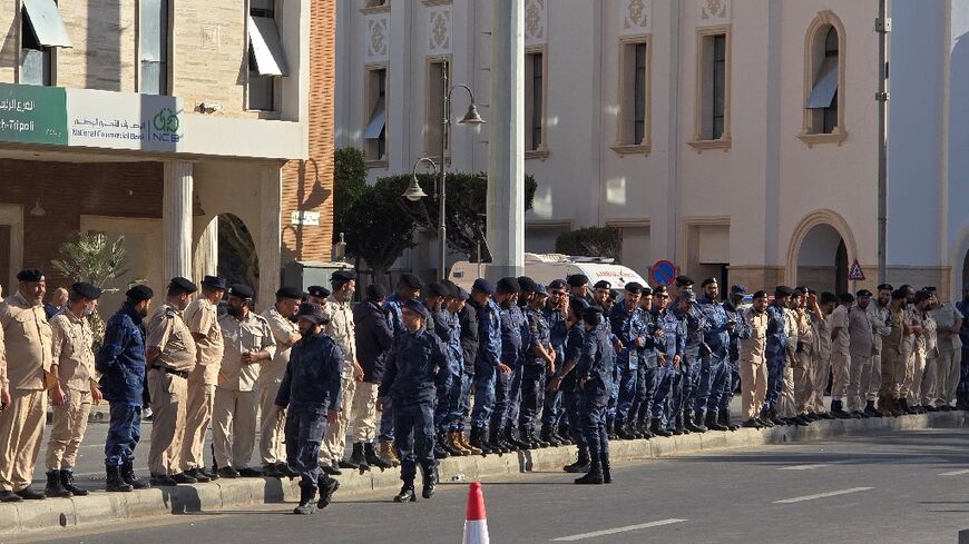 Libyan security forces line the streets as protesters gather in the capital's Martyrs' Square after days of deadly clashes to call for the resignation of the Tripoli government.