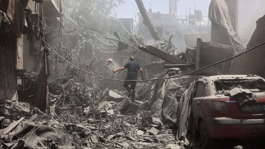 A Palestinian man inspects the rubble following Israeli strikes on a home in Tuffah neighbourhood of Gaza City