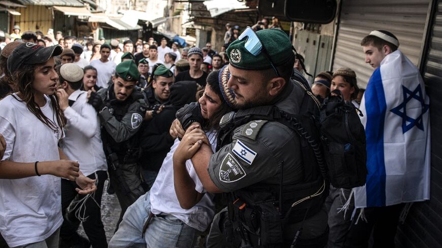 Israeli police tussle with a young man in the Old City during a march for Jerusalem Day on Monday