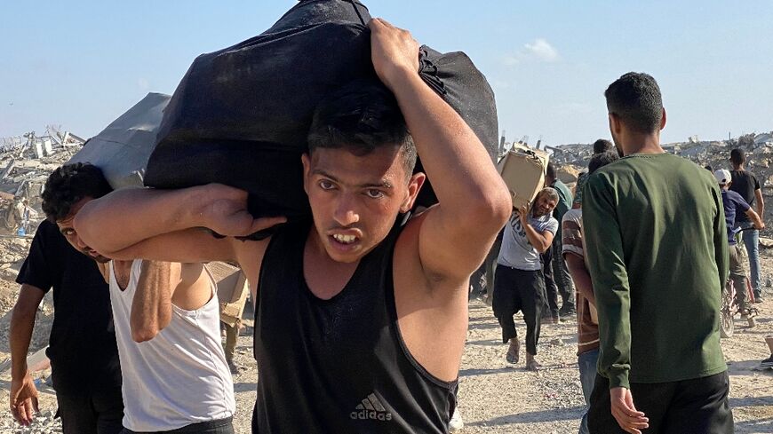 Palestinians receive food packages from a US-backed foundation in the southern Gaza Strip