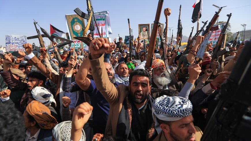 Yemenis brandish rifles as they demonstrate against Israel in the rebel-held capital Sanaa.