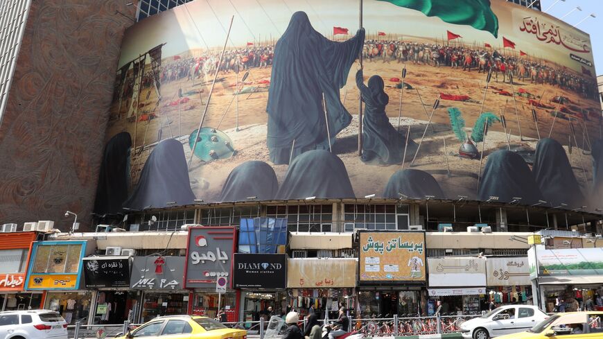A picture taken on Sept. 7, 2019, shows traffic driving past a political mural at Vali Asr Square in the Iranian capital Tehran.