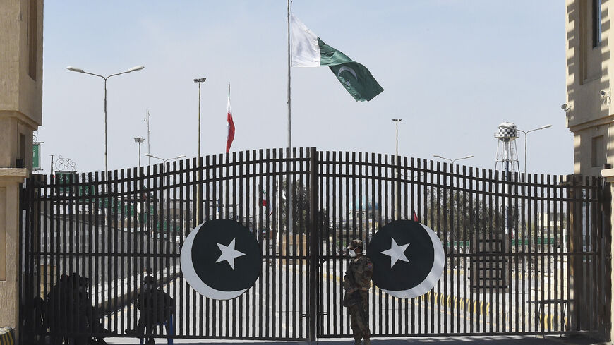 Pakistani soldiers wearing facemasks stand guard at the closed Pakistan-Iran border in Taftan on February 25, 2020 as fears over the spread of the COVID-19 coronavirus escalate following an outbreak in neighbouring Iran. - The Iranian outbreak where at least 15 people have already died -- the highest death toll in any country outside of China -- has aggravated already frayed nerves in neighbouring Afghanistan and Pakistan. (Photo by Banaras KHAN / AFP) (Photo by BANARAS KHAN/AFP via Getty Images)