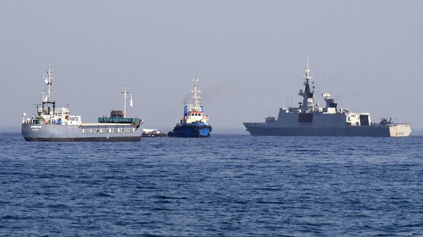 The barge Jennifer, part of a three ship flotilla carrying food aid for the Gaza Strip, sails next to the French frigate Courbet as the flotilla departs the port of Larnaca in Cyprus, March 30, 2024.