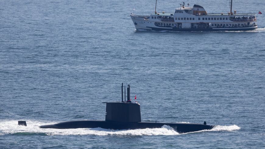 A ferry passes a Turkish Navy submarine navigating the Bosphorus on Sept. 27, 2024, in Istanbul, Turkey.