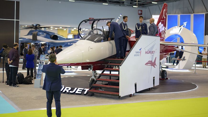 People look at the Hurjet, an advanced jet trainer light attack aircraft, during the opening day of the International Defense and Aerospace exhibition in Istanbul, Oct. 22, 2024.