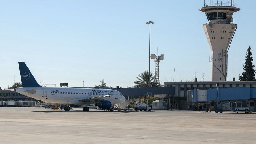 This picture shows a Syrian Arab Airlines Airbus A320-200 aircraft and the control tower at Damascus international airport as the new Syrian authorities prepare to reopen it, on December 16, 2024.