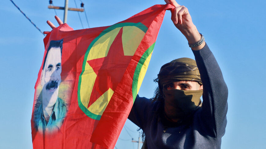 An Iraqi Kurdish woman waves a flag bearing the portrait of the founder of the Kurdistan Worker's Party (PKK) Abdullah Ocalan as people gather at Freedom Park to listen to an audio message by the jailed leader in Sulaimaniyah, in Iraq's autonomous Kurdistan region on Feb. 27, 2025.