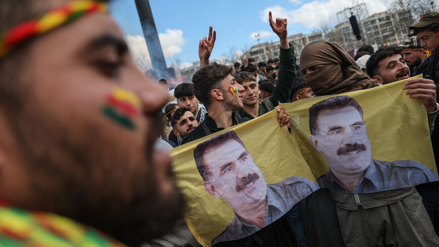 Kurdish youths holds a poster of jailed PKK militant group leader Abdullah Ocalan during Newroz celebrations on March 21, 2025 in Diyarbakir, Turkey.