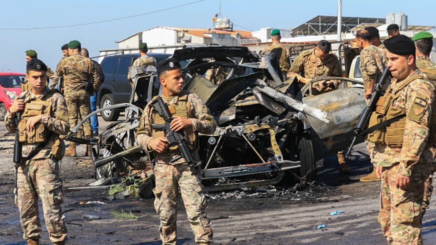 Lebanese soldiers inspect the site near a burnt-out vehicle reportedly hit by an Israeli strike in Ghazieh, near Sidon, on April 18, 2025. Lebanon's health ministry said an Israeli strike on April 18 hit a vehicle near the southern coastal city of Sidon, killing one person. Despite a November 27 ceasefire that sought to halt more than a year of all-out war between Israel and Hezbollah, Israel has continued to carry out near-daily strikes in Lebanon. (Photo by Mahmoud ZAYYAT / AFP) (Photo by MAHMOUD ZAYYAT/A