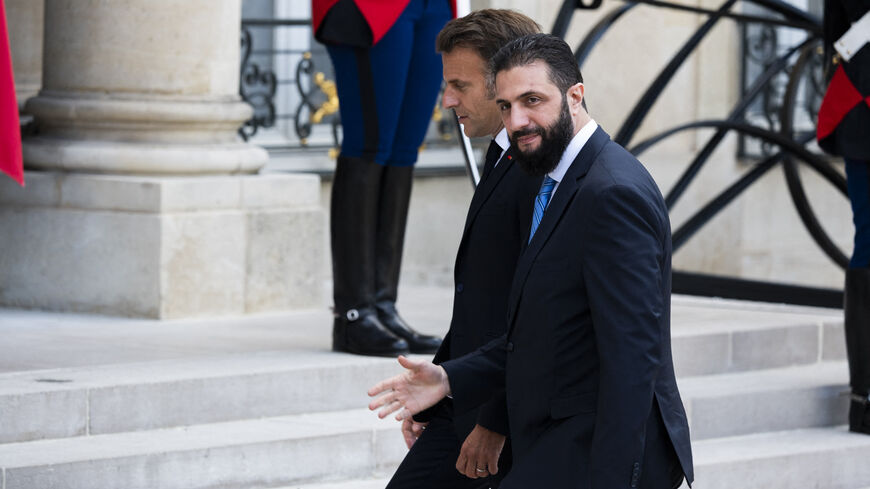France s President Emmanuel Macron (R) welcomes Syrian interim President Ahmed al-Sharaa upon his arrival for their meeting at the Elysee presidential palace in Paris on May 7, 2025. Syrian interim President Ahmed al-Sharaa arrived in Paris on May 7, state media reported, on his first visit to Europe since overthrowing longtime ruler Bashar al-Assad in December. (Photo by Magali Cohen / Hans Lucas / Hans Lucas via AFP) (Photo by MAGALI COHEN/Hans Lucas/AFP via Getty Images)