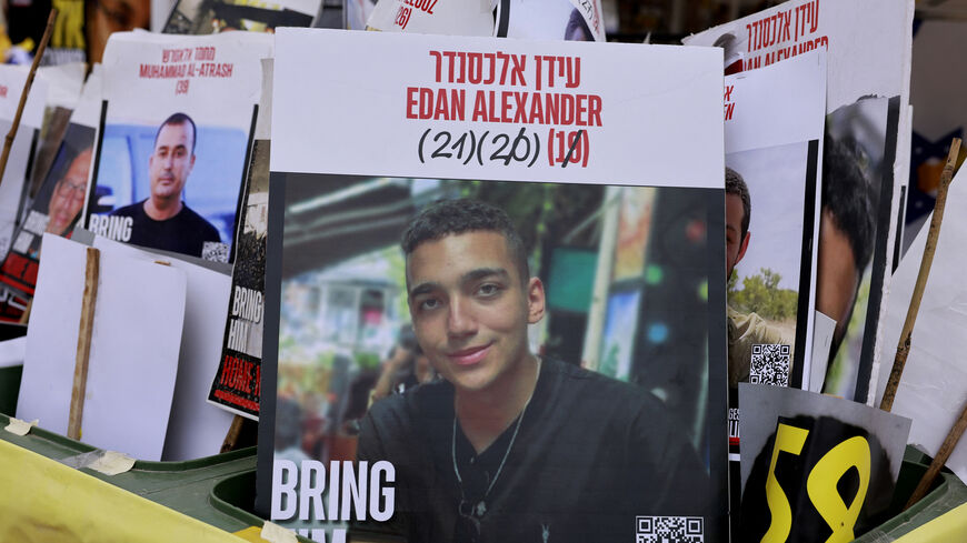 A sign showing the face of Israeli-US hostage Edan Alexander (C), who has been held by Hamas in the Gaza Strip since October 2023, is pictured among portraits of other Israelis held captive in Gaza at Hostages Square, Tel Aviv, May 12, 2025.