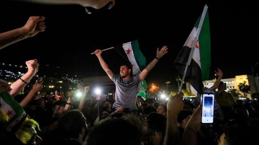 People celebrate in Damascus' Omeyyad square after US President Donald Trump's decision to lift sanctions in Syria, on May 13, 2025