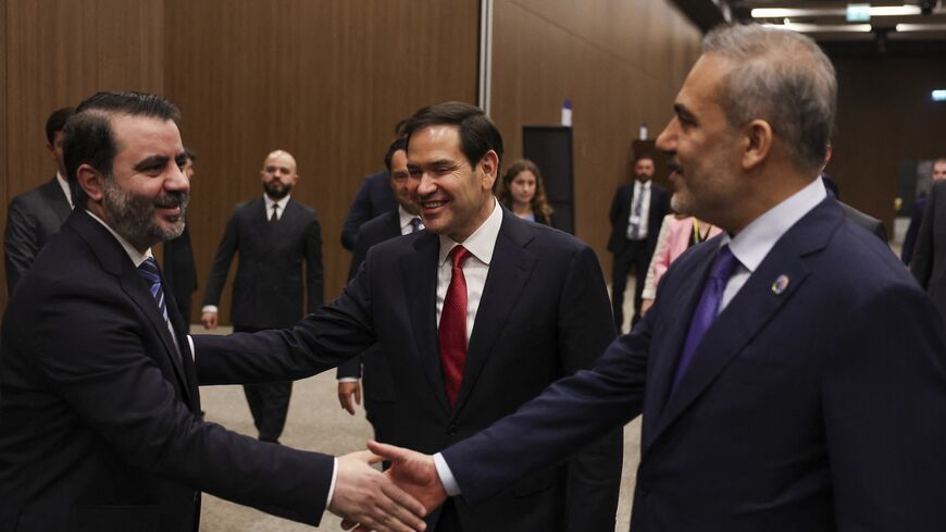 Turkish Foreign Minister Hakan Fidan (R) shakes hands with Syrian Foreign Minister Asaad Hassan al-Shaibani, and US Secretary of State Marco Rubio (C) reacts.