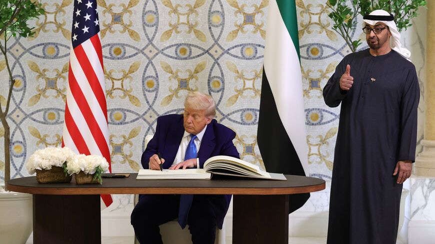 US President Donald J. Trump signs the guestbook as UAE President Sheikh Mohamed bin Zayed Al Nahyan looks on and gives a thumbs up gesture after a meeting at Qasr al-Watan (Palace of the Nation), Abu Dhabi, United Arab Emirates, May 15, 2025.