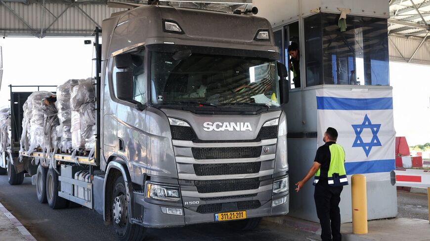 A truck carrying humanitarian aid drives through the Kerem Shalom crossing between southern Israel and the Gaza Strip, on May 22, 2025