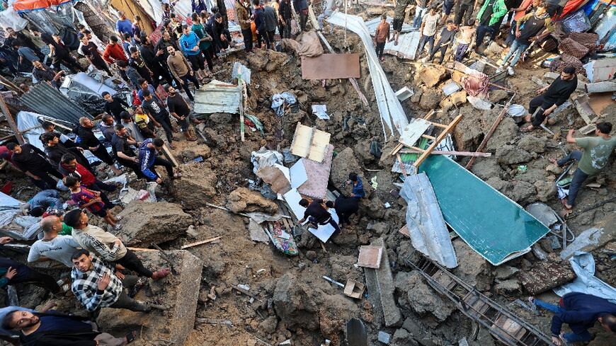People search for survivors at the site of an Israeli strike on the Bureij refugee camp in central Gaza