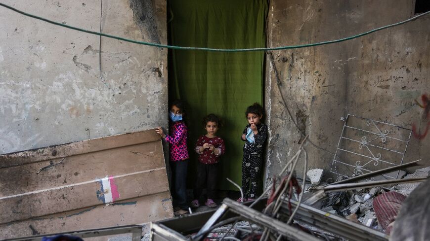 Palestinian children check the site of an Israeli strike in Jabalia