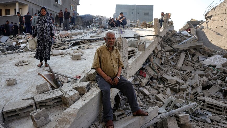 People check the destruction following an Israeli strike that hit the home of a Palestinian family in Jabalia in the northern Gaza Strip
