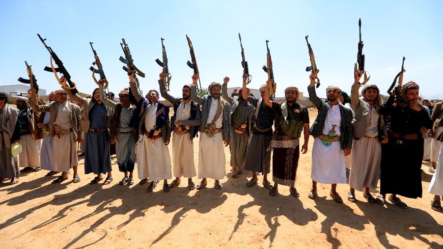 Yemenis brandish weapons as they attend the funeral of people killed in reported US strikes