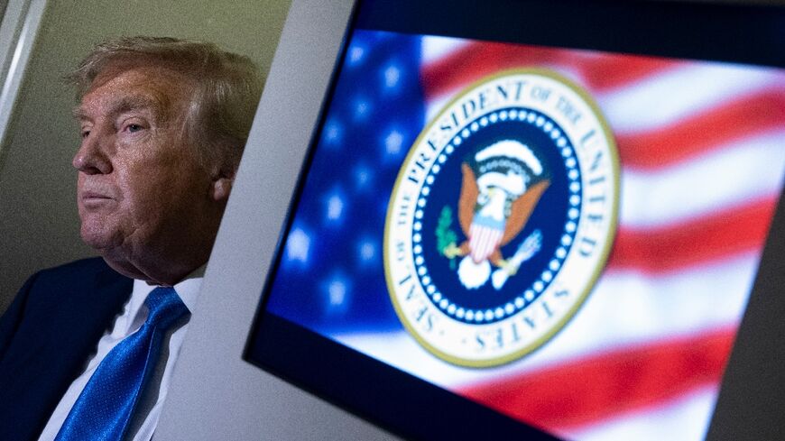 US President Donald Trump speaks to reporters about the G7 Summit aboard Air Force One while travelling back to Washington from Canada