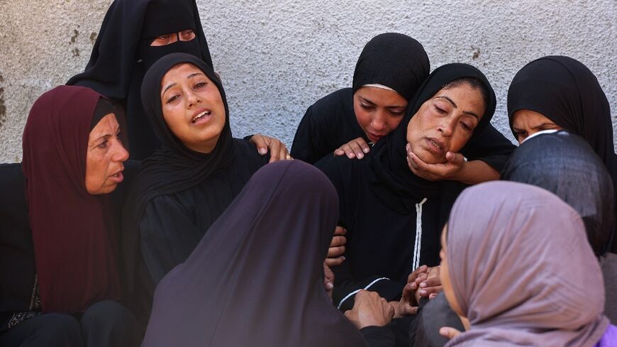 Palestinians mourn loved ones killed as they waited to queue for food in Gaza on Tuesday.
