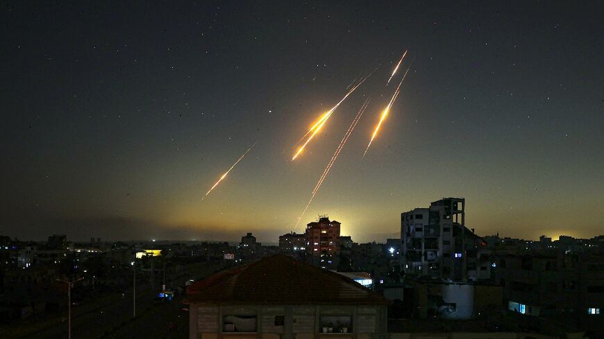 Missiles streak across the sky in this picture taken from Nuseirat in the central Gaza Strip late on June 13, 2025