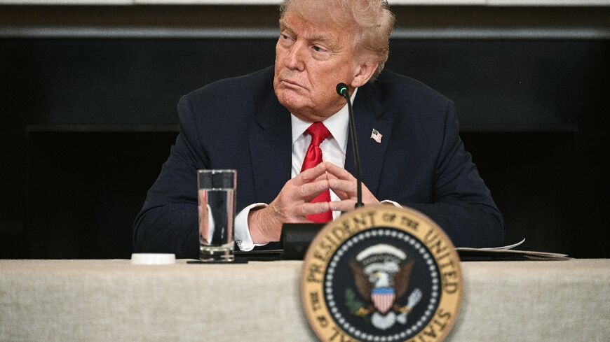 US President Donald Trump participates in an "Invest America" roundtable discussion in the State Dining Room of the White House