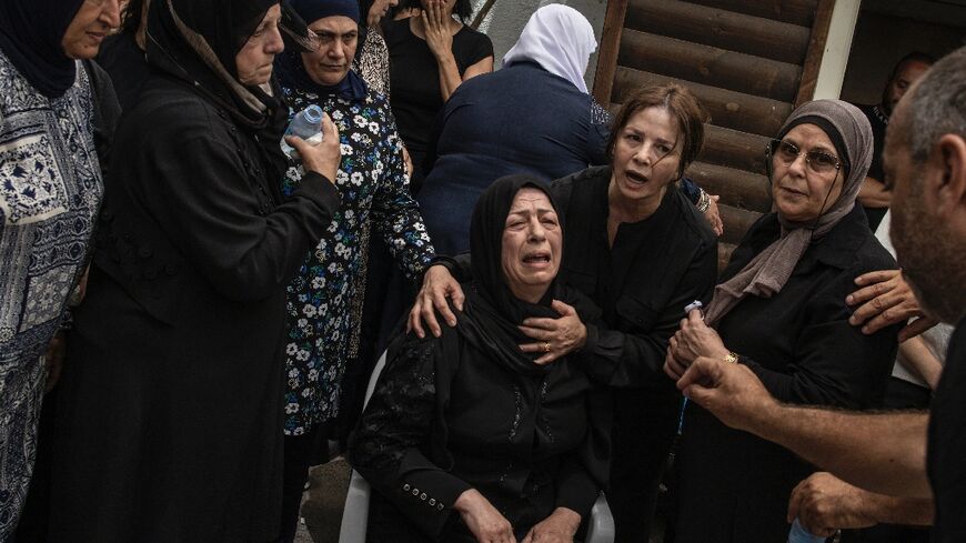 The mother of a victim of an Iranian missile attack that hit the Arab town on Tamra in northern Israel, during the funeral