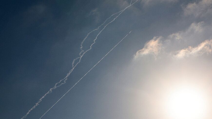 Rocket trails are seen in the sky above the Israeli coastal city of Netanya amid a fresh barrage of Iranian missile attacks 