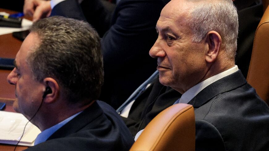 Israeli Prime Minister Benjamin Netanyahu's (R) coalition survived an opposition-backed effort to dissolve parliament, as lawmakers rejected a bill that could have paved the way for snap elections