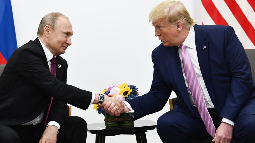 US President Donald Trump (R) attends a meeting with Russia's president, Vladimir Putin, during the G20 summit in Osaka on June 28, 2019.