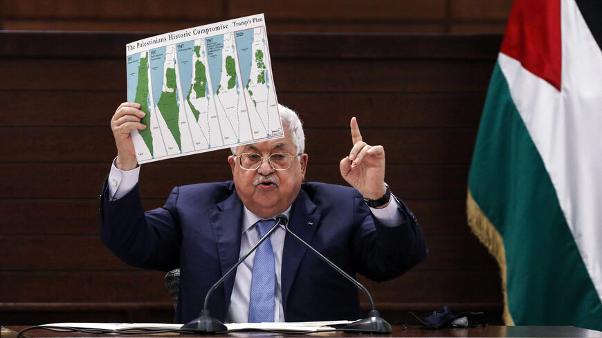 TOPSHOT - Palestinian president Mahmud Abbas holds a placard showing maps of (L to R) historical Palestine, the 1937 Peel Commission partition plan, the 1947 United Nations partition plan on Palestine, the 1948-1967 borders between the Palestinian territories and Israel, and a map of US President Donald Trump's proposal for a Palestinian state under his new peace plan, as he speaks in the West Bank's Ramallah on September 3, 2020, as he meets by video conference with representatives of Palestinian factions