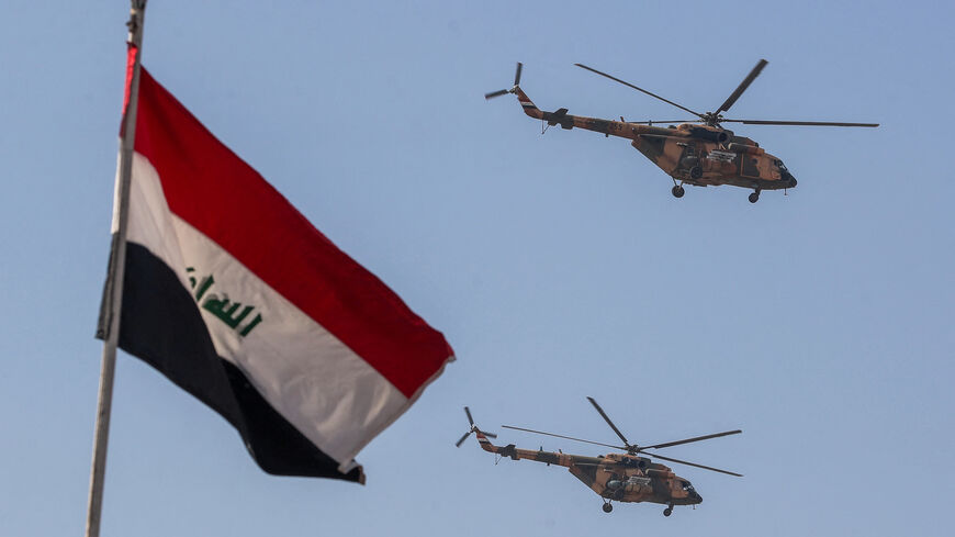 Iraqi Air Force helicopters perform during Army Day celebrations, marking the 104th anniversary of the founding of the Iraqi army, at the Camp Taji military base north Baghdad, on January 6, 2025. The Iraqi armed forces were established by the United Kingdom during their mandate over Iraq after World War I. (Photo by AHMAD AL-RUBAYE / AFP) (Photo by AHMAD AL-RUBAYE/AFP via Getty Images)