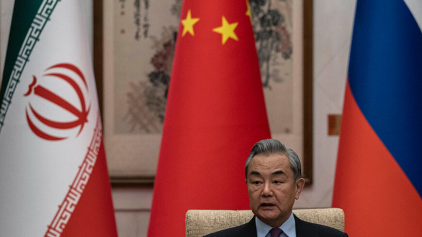 China's Foreign Minister Wang Yi, speaks during a meeting with Russia's Deputy Foreign Minister Sergey Ryabkov (not pictured) and Iran's Deputy Foreign Minister Kazeem Gharibabadi (not pictured) regarding the Iranian nuclear issue at the Diaoyutai State Guesthouse in Beijing on March 14, 2025. China urged an end to "illegal" sanctions on Iran as it hosted diplomats from that country and Russia on March 14 for talks Beijing hopes will restart long-stalled negotiations on Tehran's nuclear programme. (Photo by