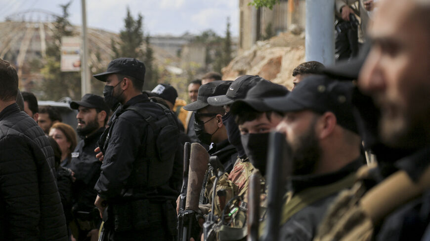 Armed personnel of SDF and public security forces of the new Syrian government stand guard as nearly a hundred prisoners are exchanged between the Kurdish-led Syrian Democratic Forces (SDF) and the new Syrian government in al-Ramun district of Aleppo, Syria, on April 3, 2025.