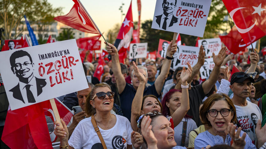 Protesters hold Turkish flags and placards reading 'Freedom for Imamoglu' as they take part in a demonstration against the detention of the Mayor of Istanbul, Ekrem Imamoglu, organized by the country's main opposition, the Republican People's Party (CHP), at Beyazid Square, in Istanbul, May 7, 2025.