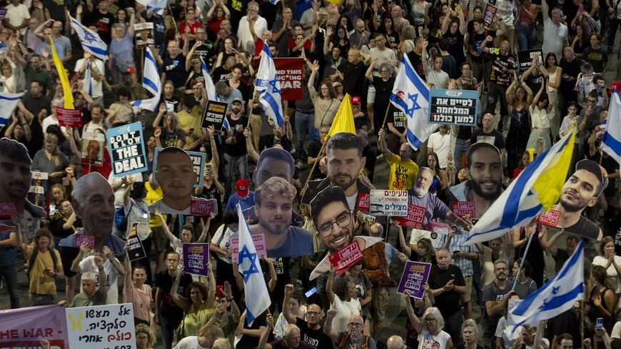 Protesters hold signs and photos of hostages held in the Gaza Strip by Hamas during a rally calling for a hostage deal, May 31, 2025 in Tel Aviv, Israel.