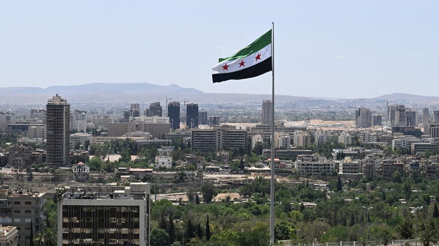 A large Syrian flag flutters above Tishreen Park in Damascus, on June 4, 2025.