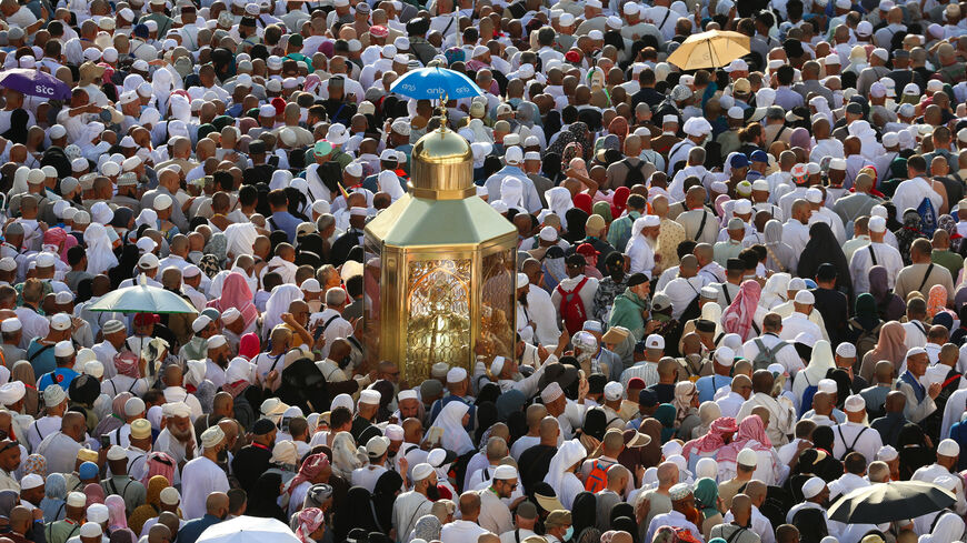 Muslim worshippers make their way towards the Kaaba, Islam's holiest shrine, at the Grand Mosque complex in in the holy city of Mecca to take part in morning prayers on the first day of Eid Al-Adha, the feast of the sacrifice, early on June 6, 2025.