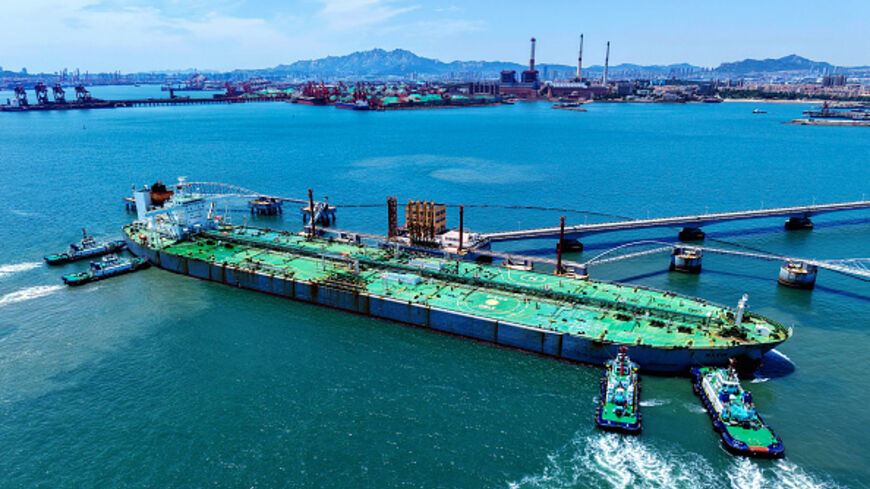 A ship loaded with oil docks at a pier with the help of a tugboat at the port of Qingdao, in eastern China's Shandong province, on June 12, 2025. Photo by STR/AFP via Getty Images