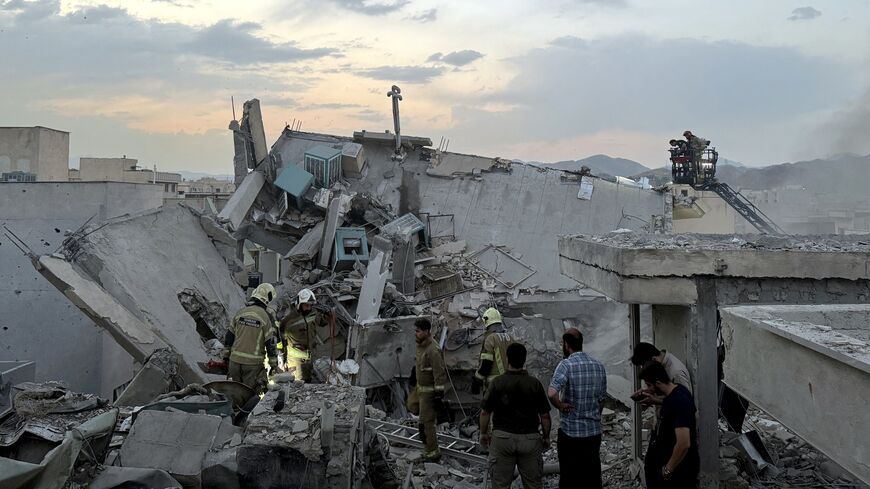 People and first-responders gather atop a building hit by an Israeli strike, Tehran, June 13, 2025.